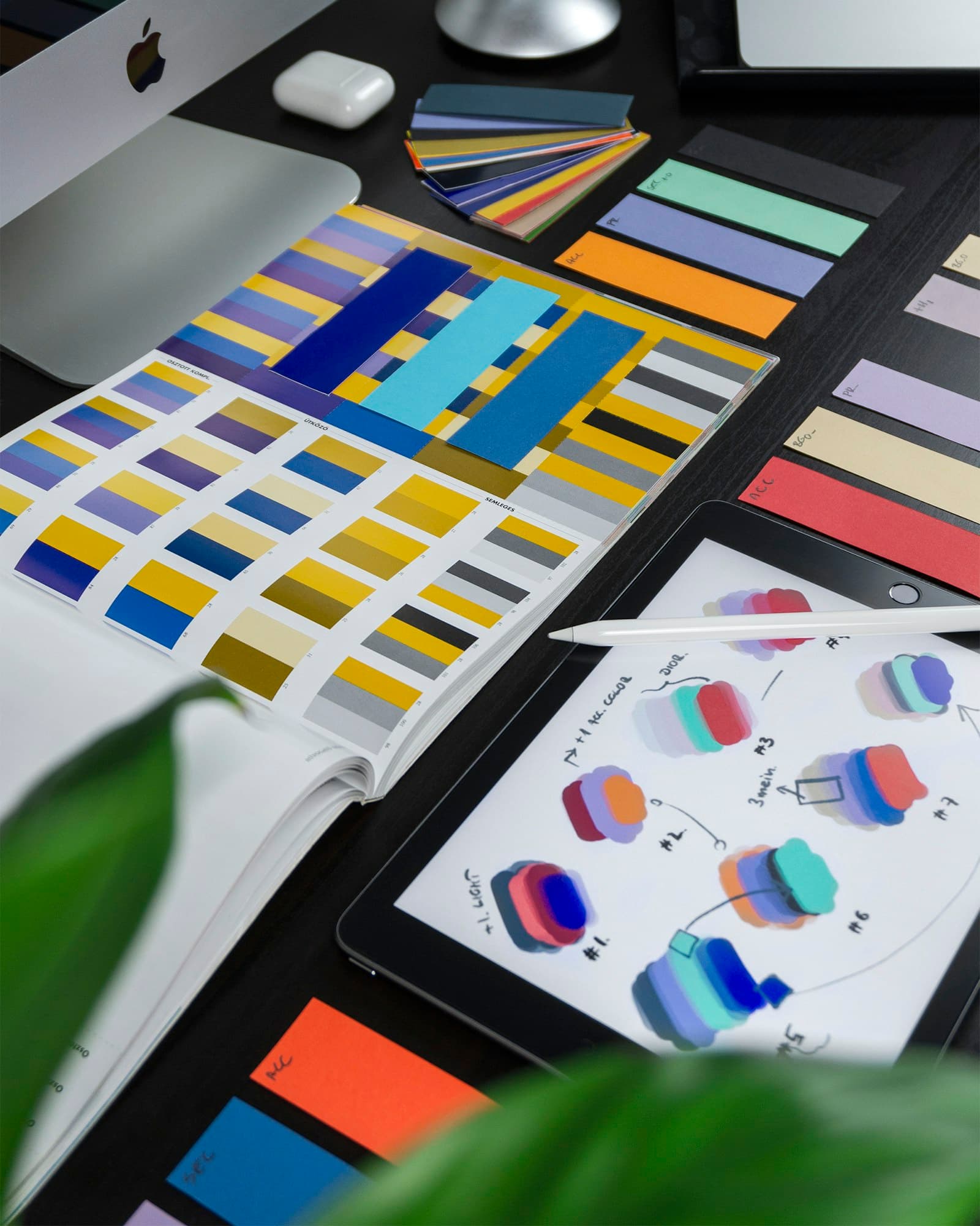 Colour swatches and printed design proofs on a desk