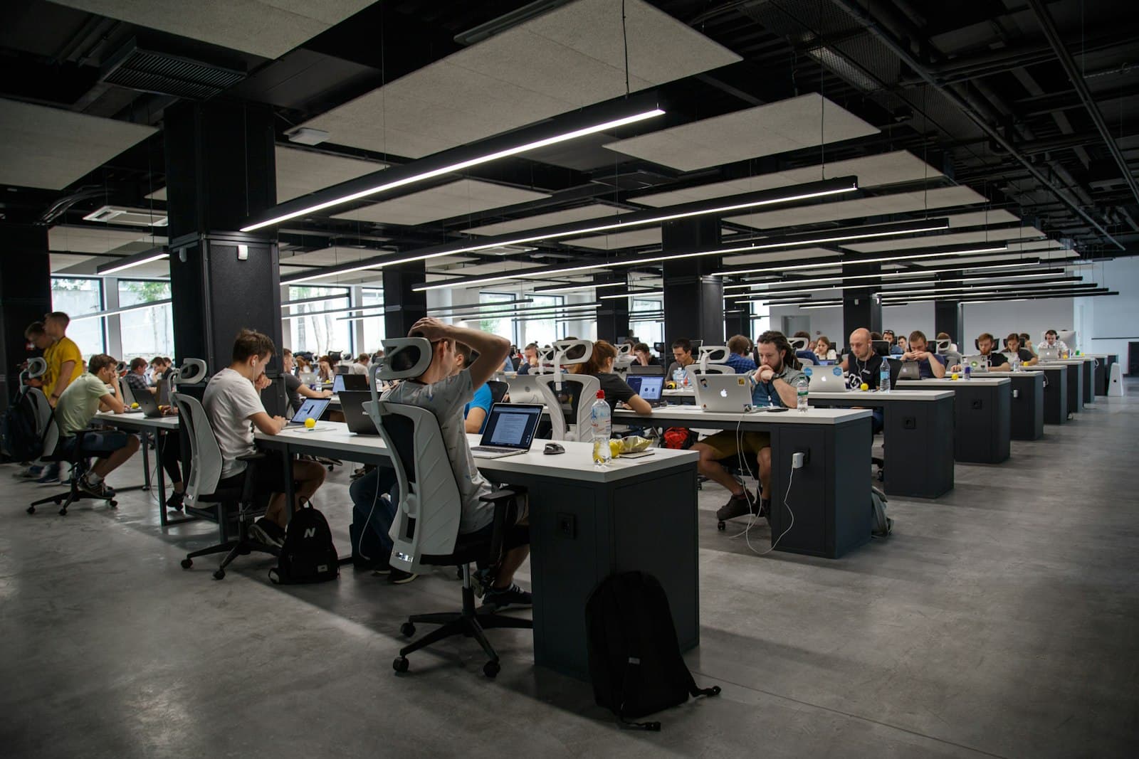 Large open-plan office floor with rows of desks