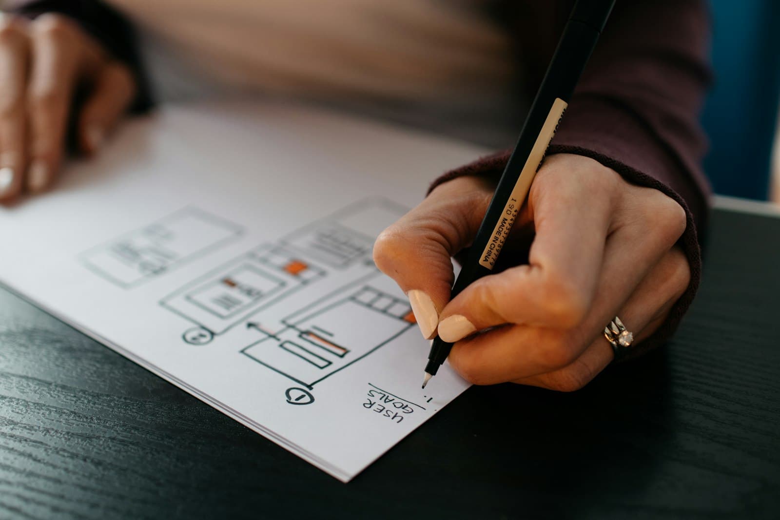 Hand sketching website wireframes on paper
