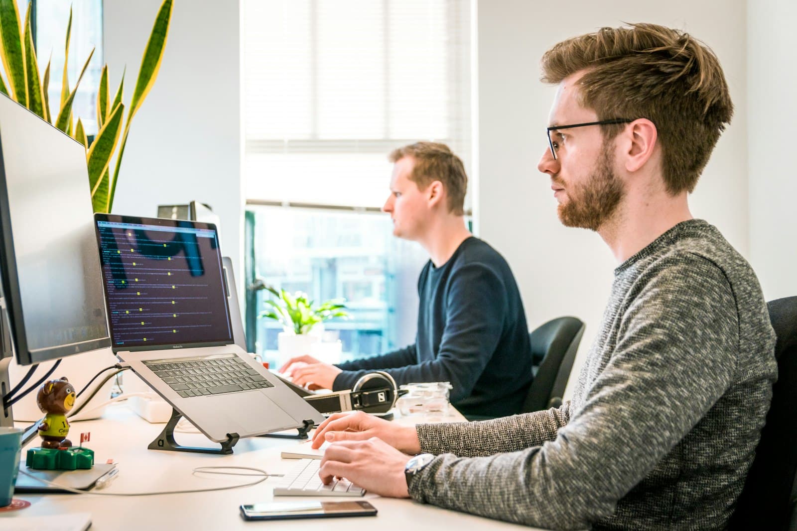 Two developers looking at a monitor together